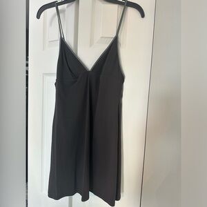 Strappy black top. Silver straps. Vneck